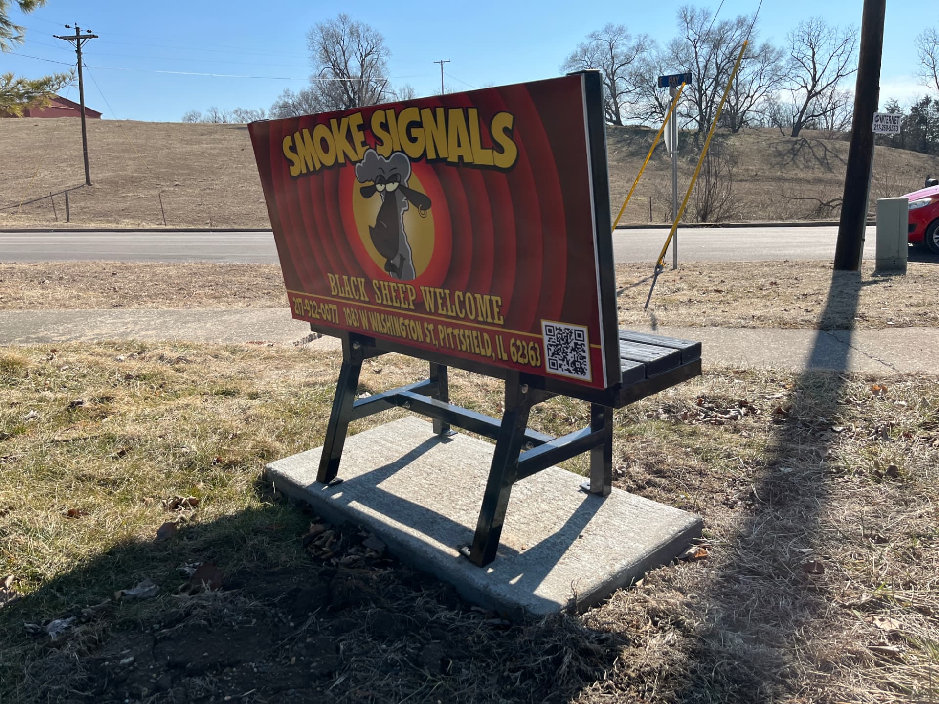 Smoke Signals Benchboard installed beside a well-traveled road
